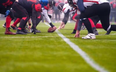 group of young professional american football players ready to start during match on the stadium field